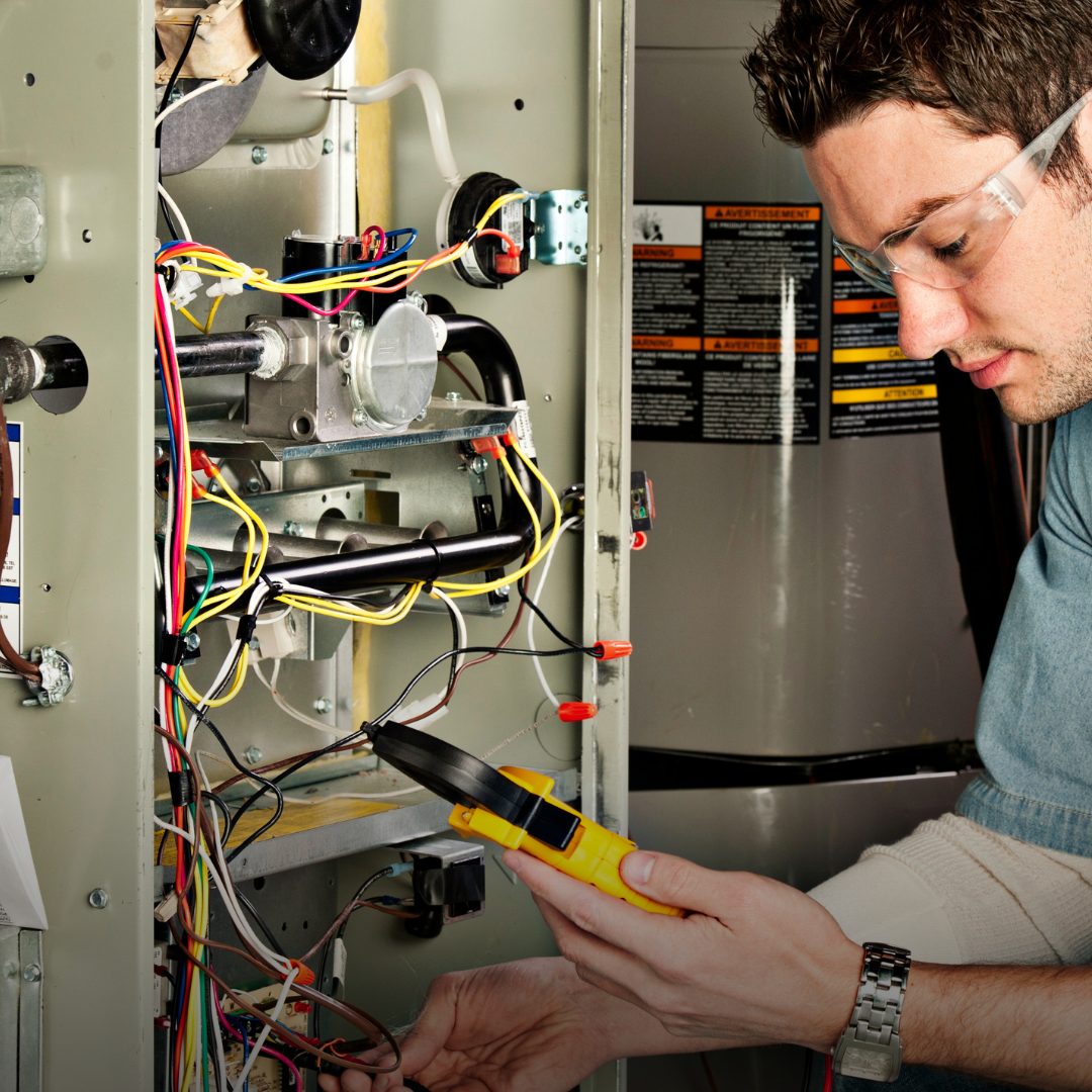 Climate Control Specialist Technician performing a heating system repair on a malfunctioning furnance in Lebanon OH.